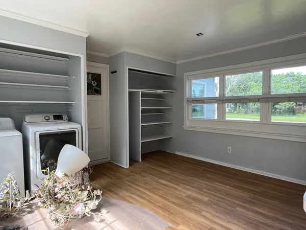 a view of a livingroom with furniture wooden floor and window