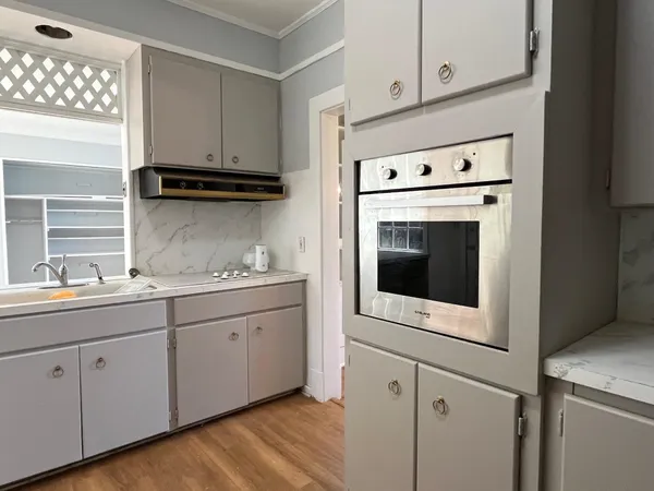 a kitchen with granite countertop white cabinets white stainless steel appliances and sink