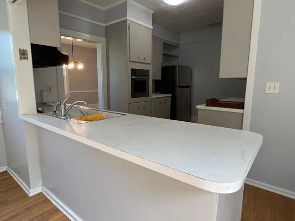 a kitchen with stainless steel appliances a refrigerator and a stove top oven