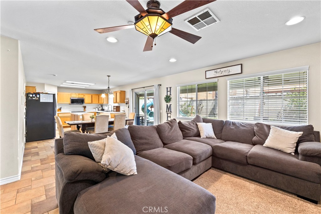 7219 Birch Tree Place Fontana, CA 92336 - Photo 11 of 49 a living room with furniture ceiling fan and a large window