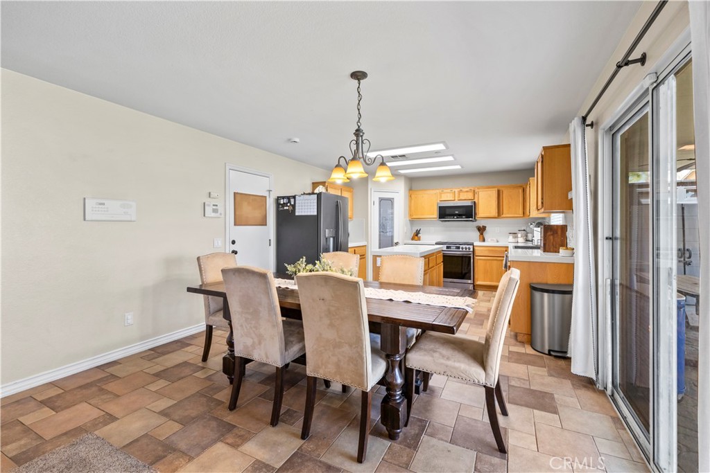 7219 Birch Tree Place Fontana, CA 92336 - Photo 16 of 49 a view of a dining room with furniture window and wooden floor
