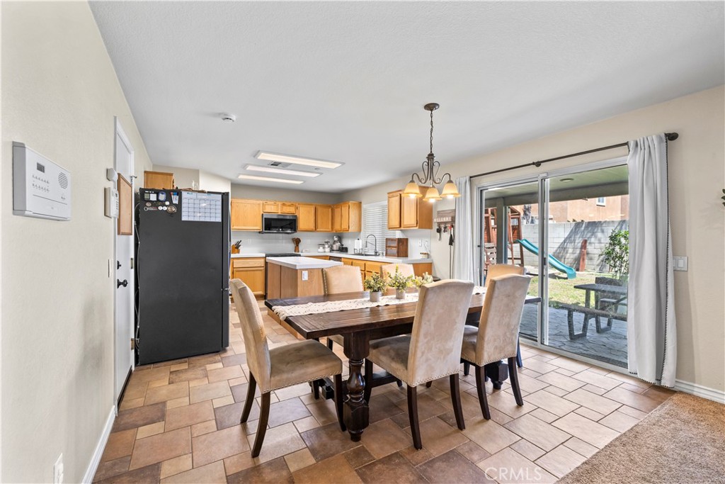 7219 Birch Tree Place Fontana, CA 92336 - Photo 17 of 49 a dining room with furniture a chandelier and a rug