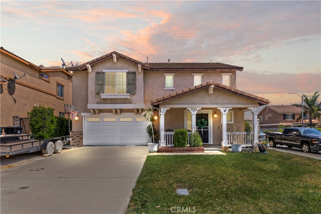 7219 Birch Tree Place Fontana, CA 92336 - Photo 2 of 49 a front view of a house with a yard and garage