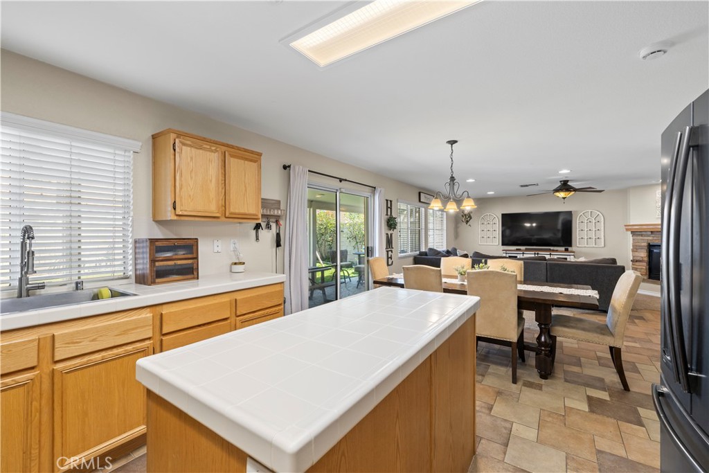 7219 Birch Tree Place Fontana, CA 92336 - Photo 21 of 49 a large kitchen with a table and chairs in it