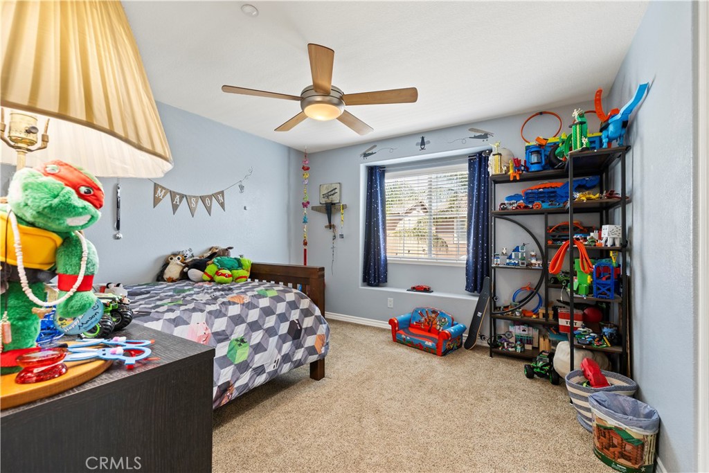 7219 Birch Tree Place Fontana, CA 92336 - Photo 23 of 49 a bed room with a bed mirror and a window