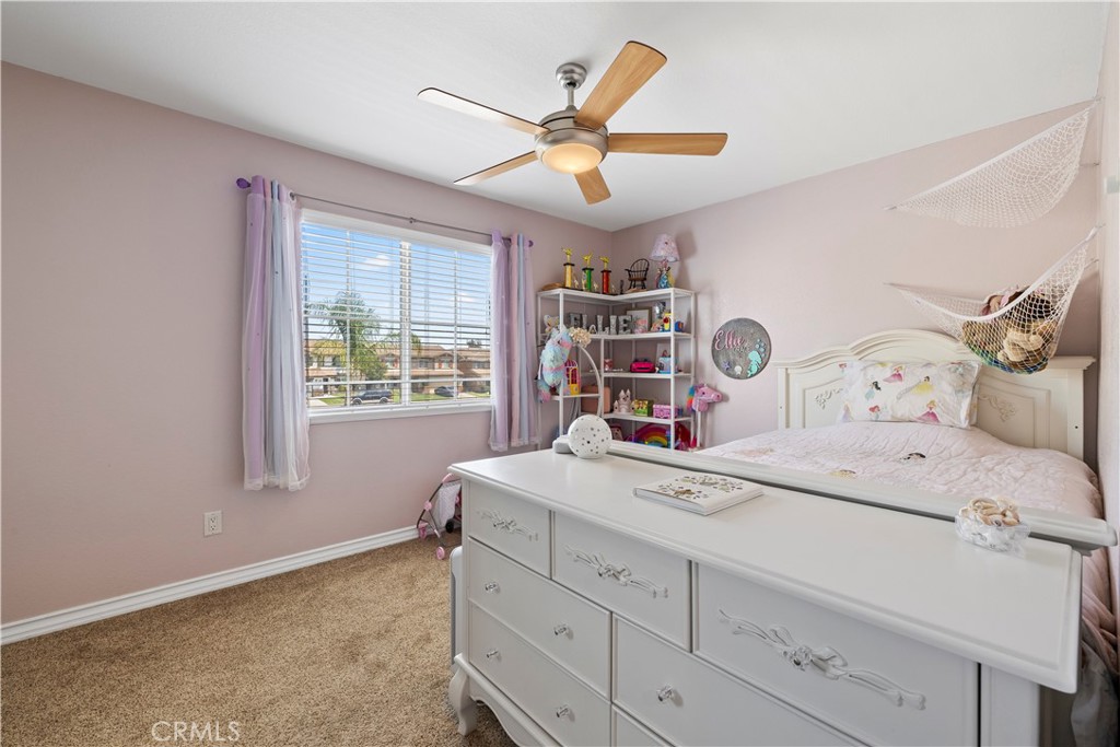 7219 Birch Tree Place Fontana, CA 92336 - Photo 25 of 49 a bedroom with a bed and a large window