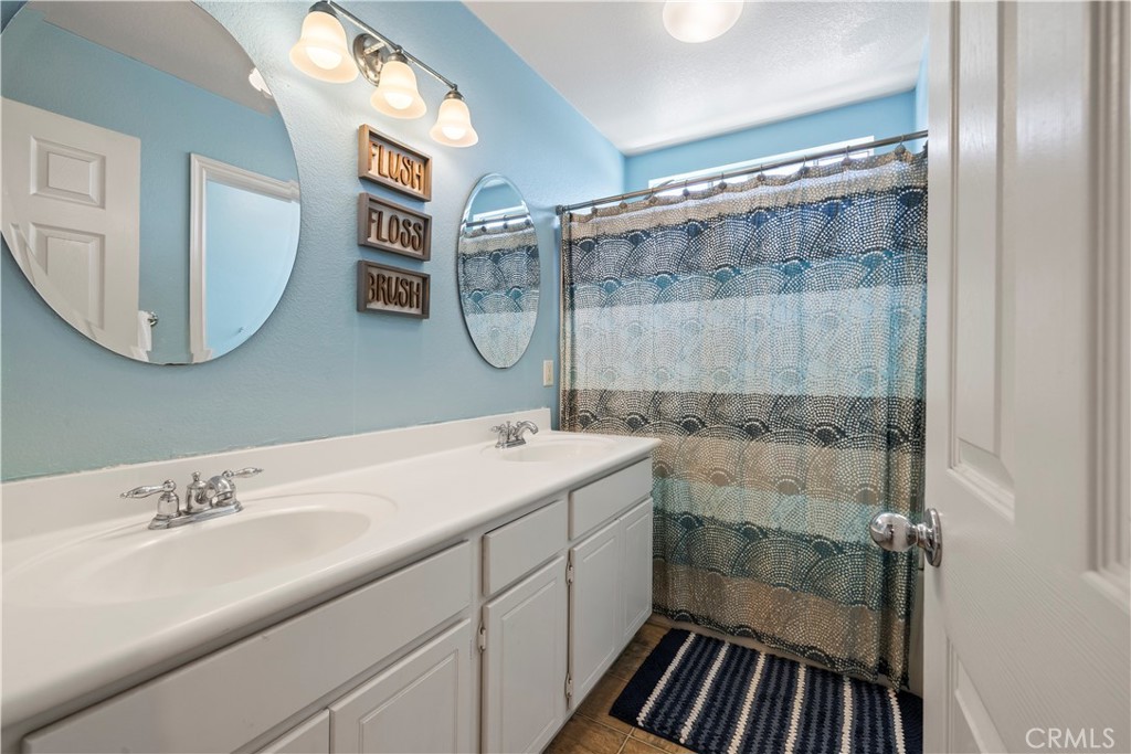 7219 Birch Tree Place Fontana, CA 92336 - Photo 27 of 49 a bathroom with a sink and a mirror
