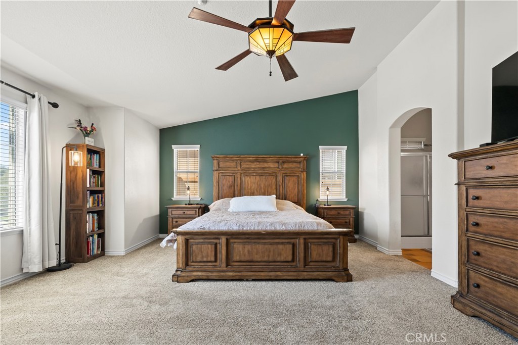 7219 Birch Tree Place Fontana, CA 92336 - Photo 33 of 49 a bedroom with a bed and a chandelier