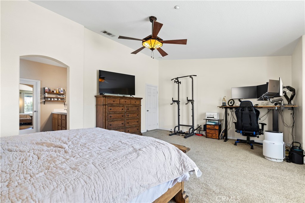 7219 Birch Tree Place Fontana, CA 92336 - Photo 35 of 49 a bedroom with a bed and a flat tv screen on dresser