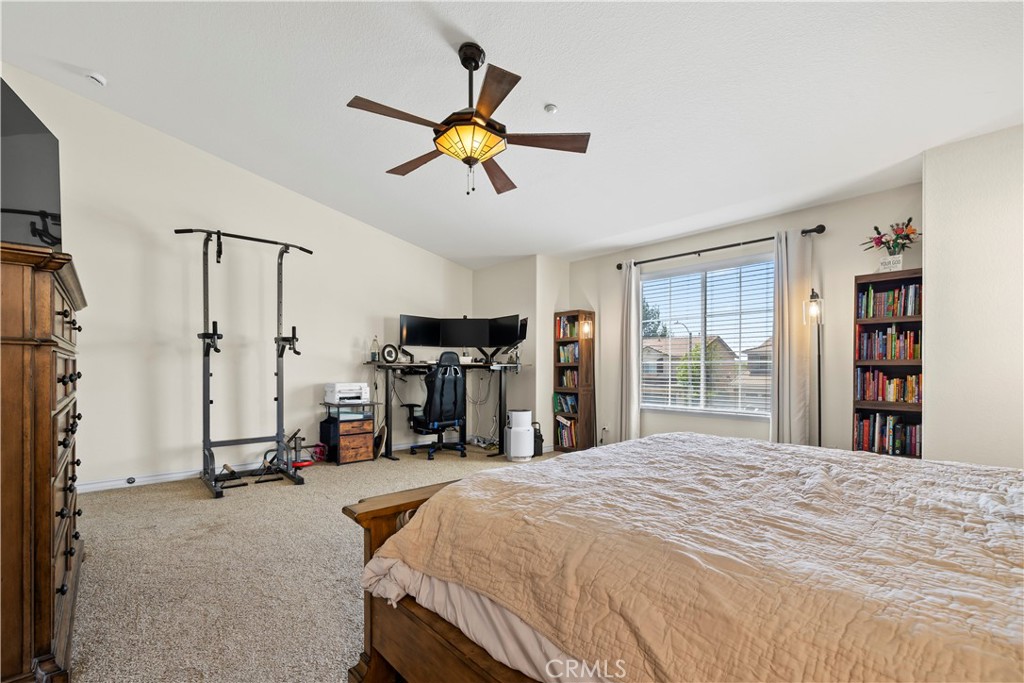 7219 Birch Tree Place Fontana, CA 92336 - Photo 36 of 49 a bedroom with a bed and a chandelier