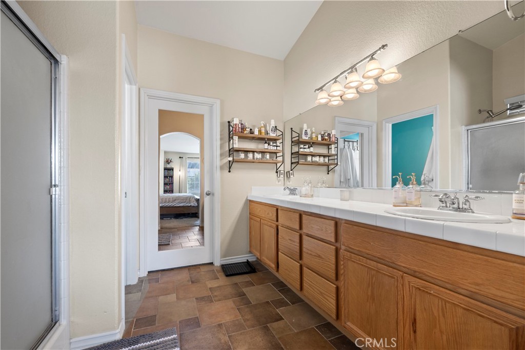 7219 Birch Tree Place Fontana, CA 92336 - Photo 37 of 49 a spacious bathroom with a double vanity sink a mirror and a shower