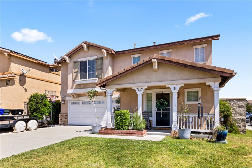 7219 Birch Tree Place Fontana, CA 92336 - Photo 4 of 49 a front view of a house with a yard