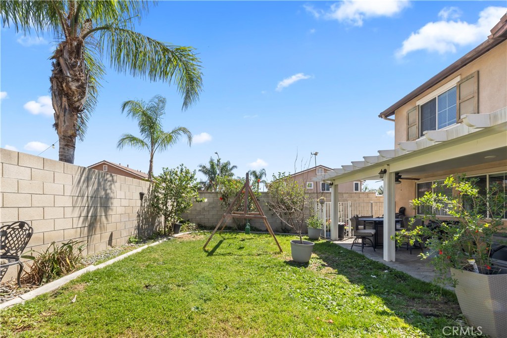 7219 Birch Tree Place Fontana, CA 92336 - Photo 44 of 49 a backyard of a house with potted plants and palm tree