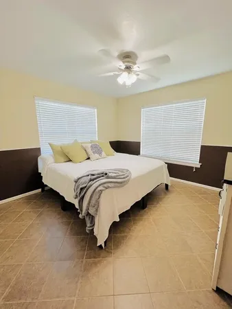 an empty room with windows and cabinet