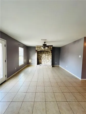 a view of an empty room and a window