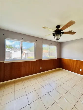 a large white kitchen with a large window