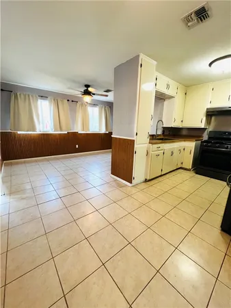 a kitchen with stainless steel appliances kitchen island granite countertop a refrigerator and a sink