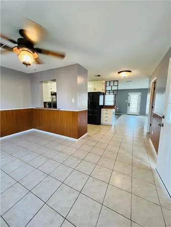 a view of a livingroom with a ceiling fan and window