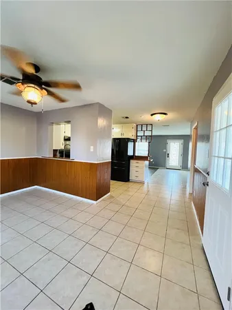 a view of a livingroom with a ceiling fan and window