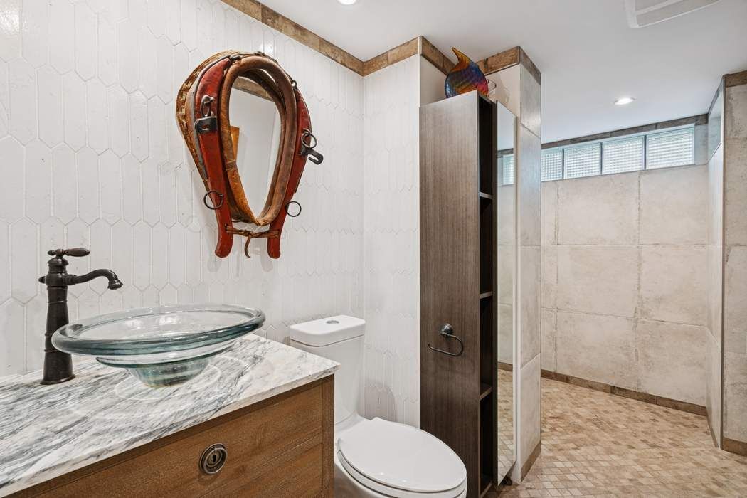 361 Dean Street Brooklyn, NY 11217 - Photo 11 of 18 a bathroom with a granite countertop sink mirror vanity and toilet