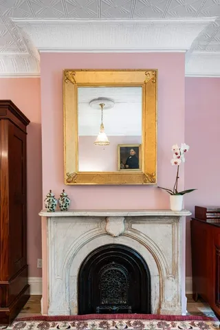 a bedroom with furniture and a fireplace