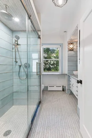 a living room with furniture a fireplace and a chandelier