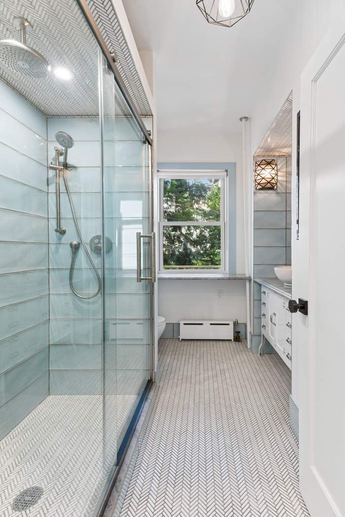 361 Dean Street Brooklyn, NY 11217 - Photo 16 of 18 a bathroom with a bathtub and a shower