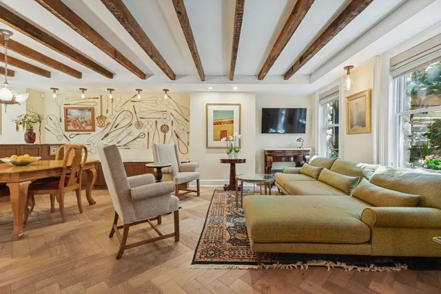 a living room with furniture a flat screen tv and a large window