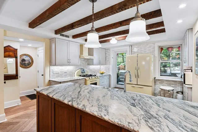 a living room with stainless steel appliances granite countertop furniture and a kitchen view