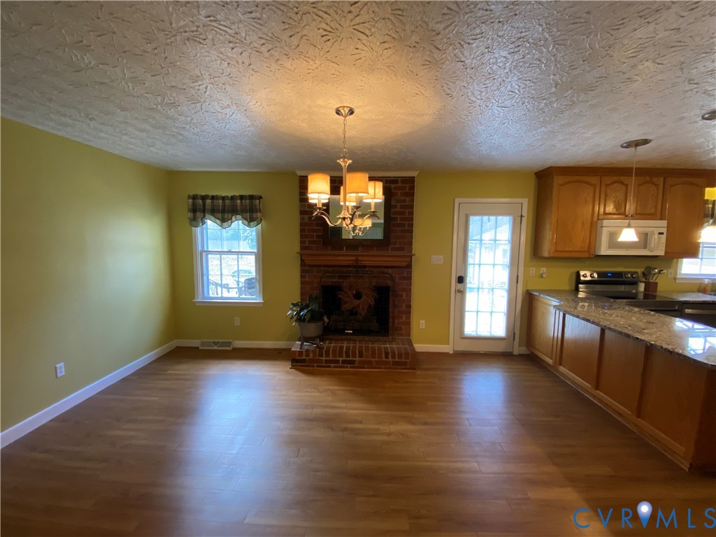 3766 Venter Road Richmond, VA 23227 - Photo 11 of 50 a view of a livingroom with a fireplace a window and wooden floor