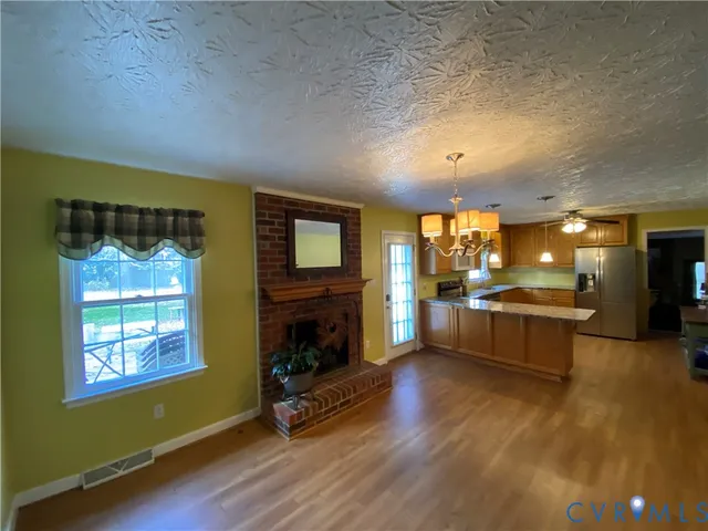an open kitchen with furniture and a fireplace