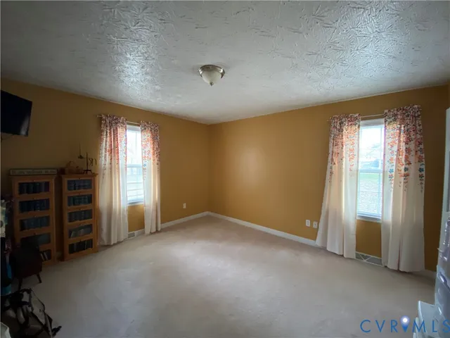 an empty room with furniture and windows