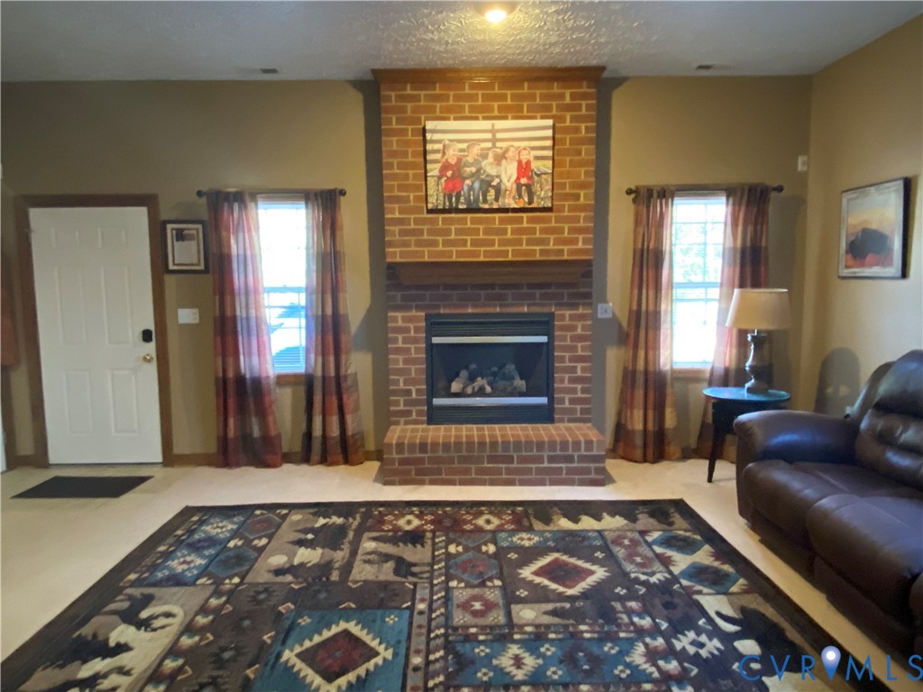 3766 Venter Road Richmond, VA 23227 - Photo 26 of 50 a living room with a couch and a fireplace