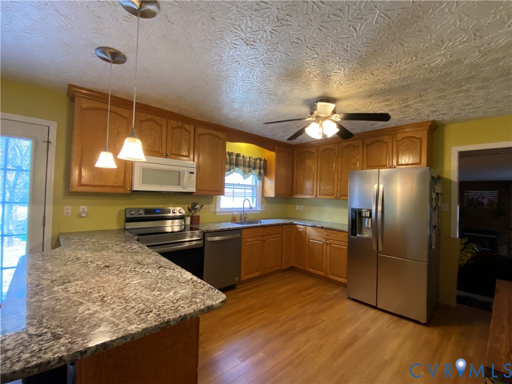 3766 Venter Road Richmond, VA 23227 - Photo 40 of 50 a kitchen with stainless steel appliances granite countertop a sink stove and refrigerator