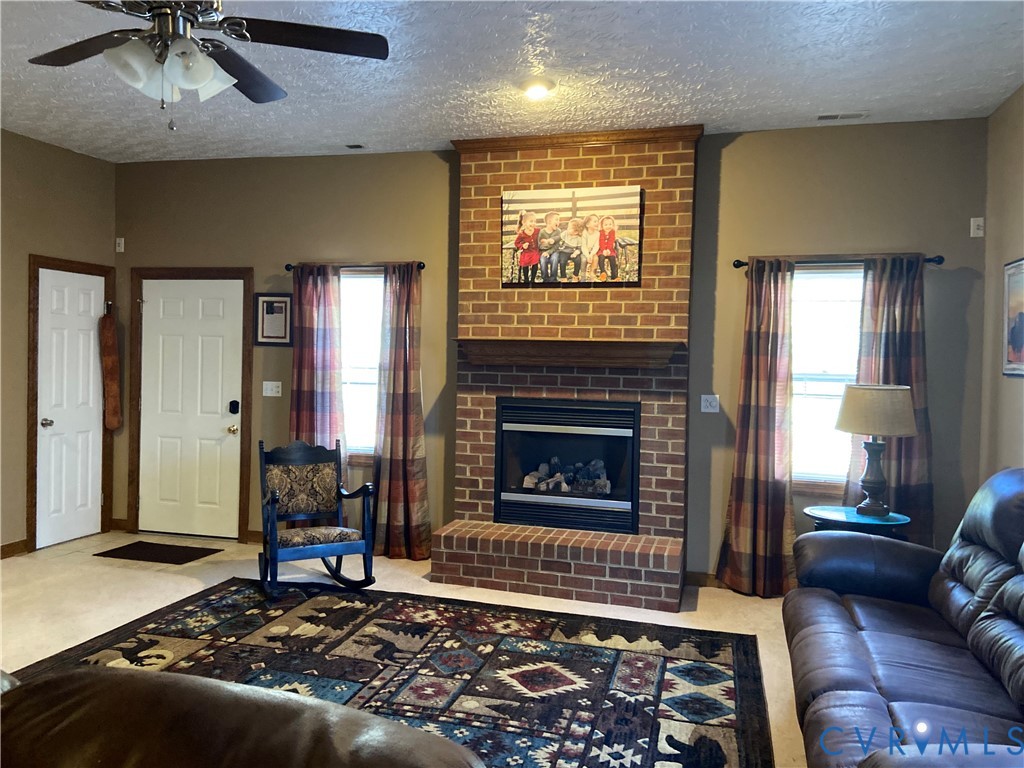 3766 Venter Road Richmond, VA 23227 - Photo 4 of 50 a living room with furniture and a fireplace