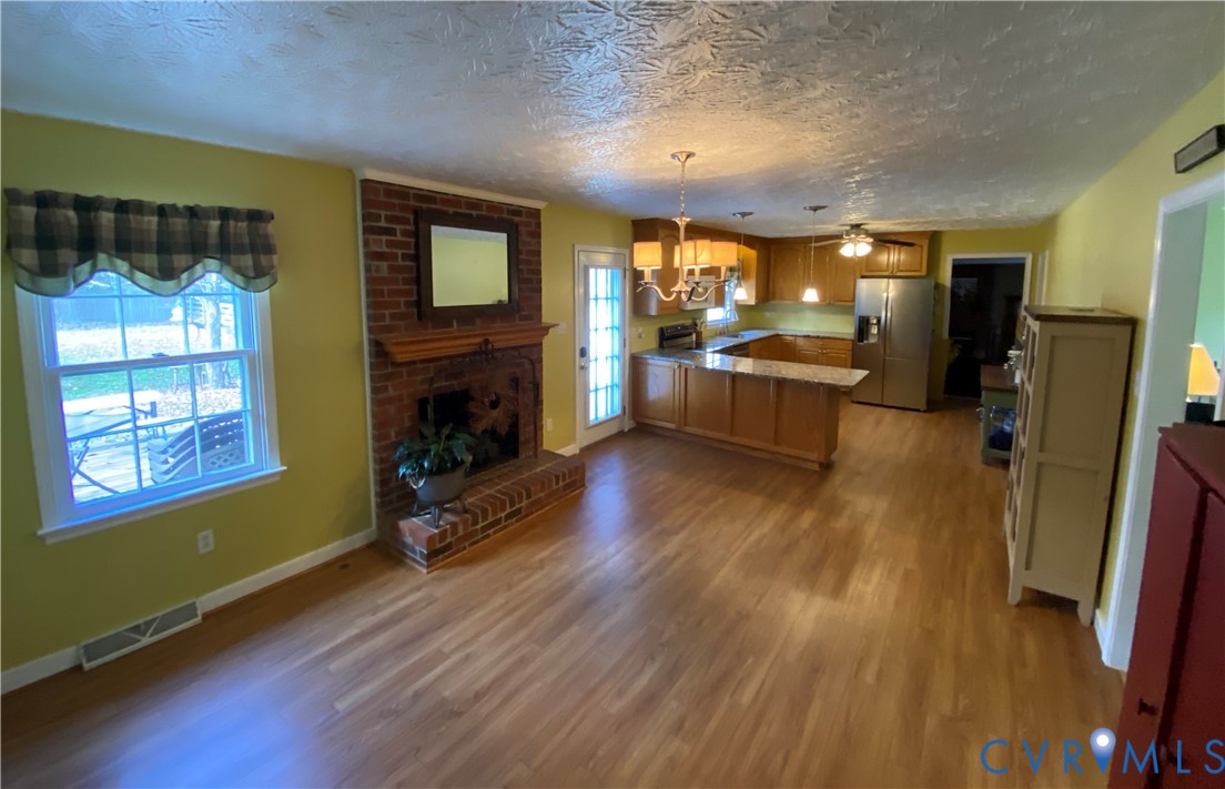 3766 Venter Road Richmond, VA 23227 - Photo 45 of 50 a large living room with a fireplace and wooden floor