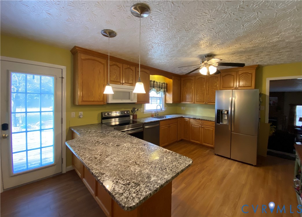3766 Venter Road Richmond, VA 23227 - Photo 46 of 50 a kitchen with stainless steel appliances granite countertop a sink stove and refrigerator