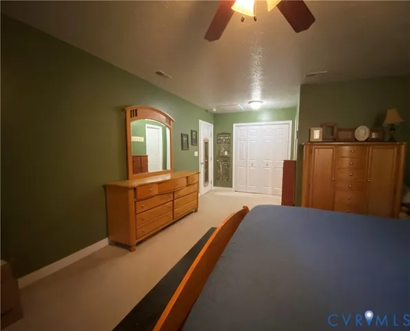 a spacious bedroom with a bed and a chandelier