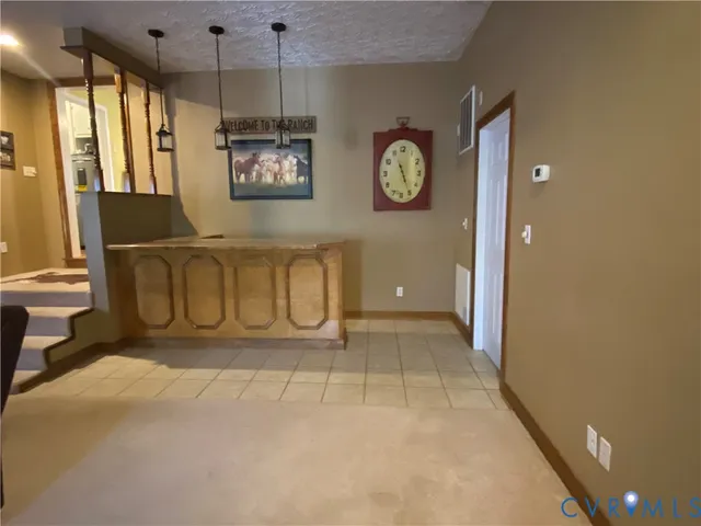a view of a hallway with window and chandelier
