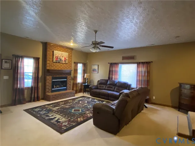 a living room with furniture and a fireplace