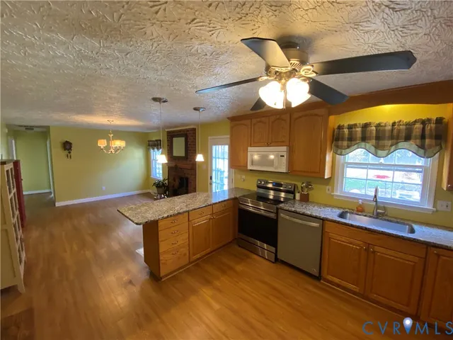a kitchen with stainless steel appliances granite countertop a sink and a stove
