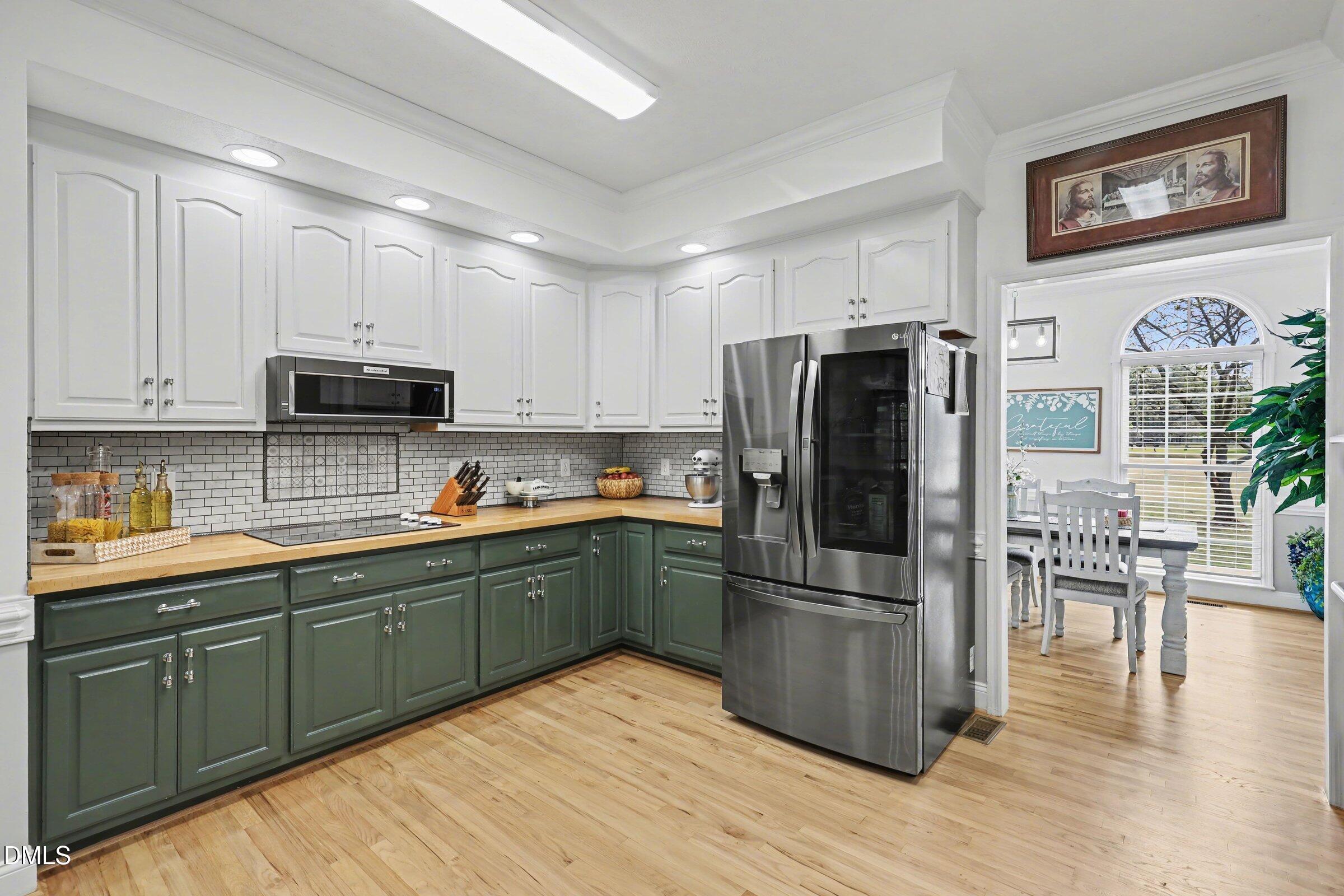 430 Fred Hall Road Stedman, NC 28391 - Photo 13 of 63 a kitchen with stainless steel appliances granite countertop a refrigerator a stove a sink and a microwave