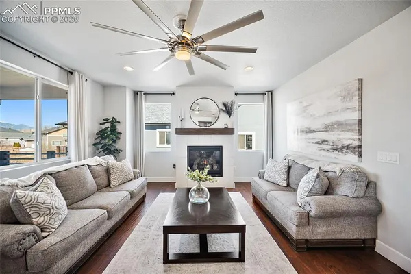 a living room with furniture and a floor to ceiling window