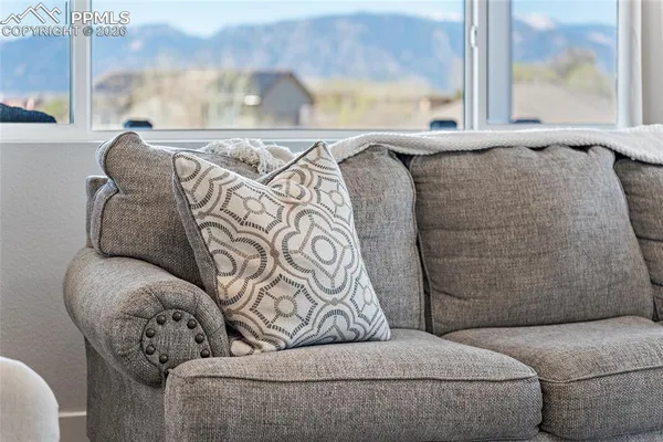 a living room with kitchen island furniture and a chandelier