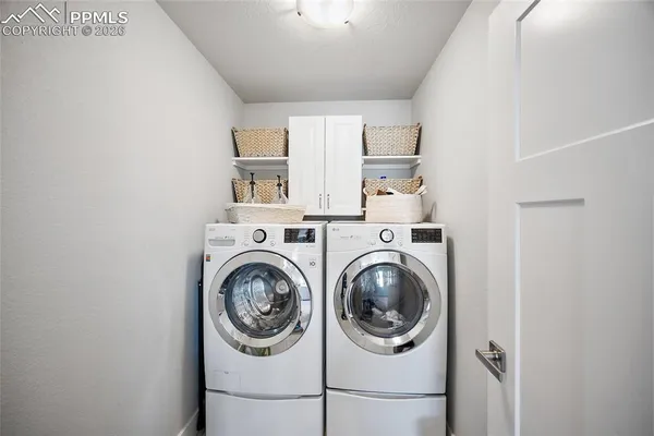 a bedroom with a bed window and dresser