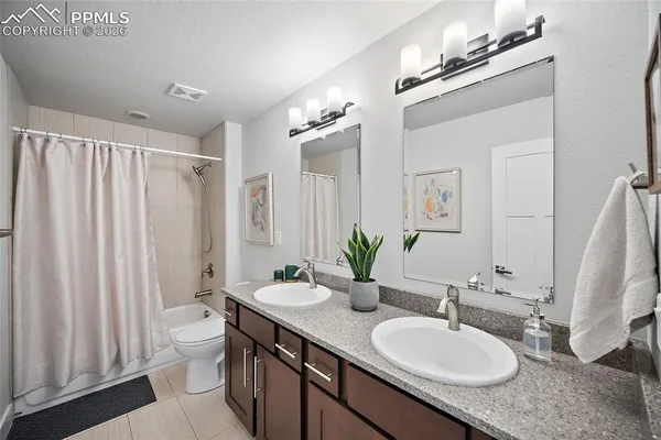 a bedroom with a bed and a lamp