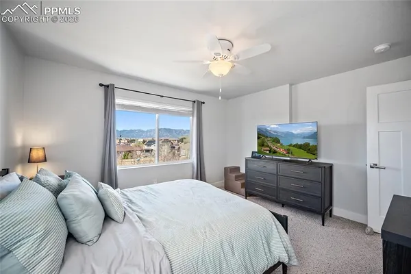 a bedroom with a large bed and a window