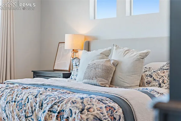 a bedroom with a bed and window