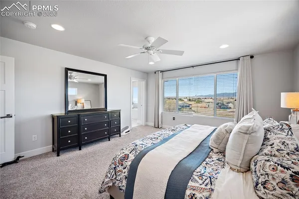 a spacious bathroom with a tub sink and mirror