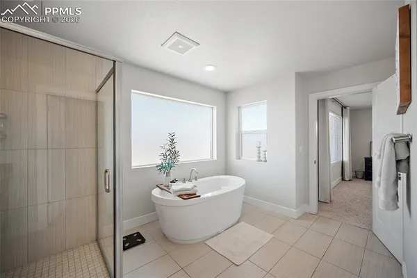 a bathroom with a granite countertop sink a mirror a vanity and a shower